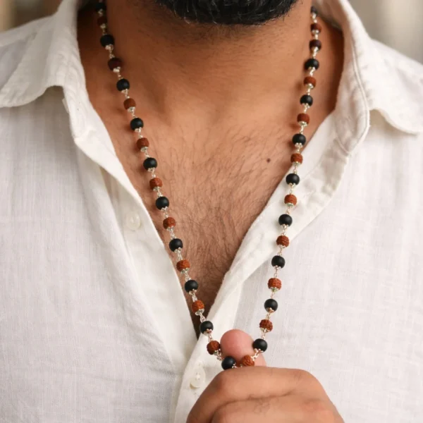 boy wearing karungali and rudraksha mala