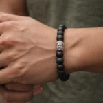 boy wearing karungali bracelet with buddha bead